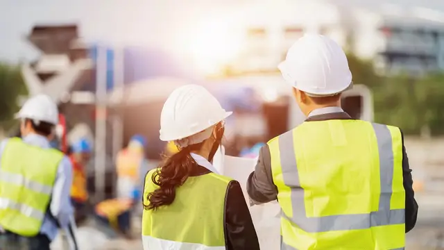 Site workers in hi-vis and hard hats